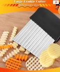 Large crinkle cutter with black ergonomic handle and ridged stainless blade on wooden cutting board beside potatoes.