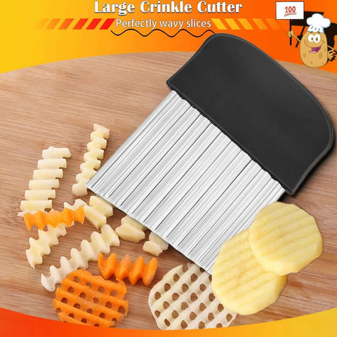 Large crinkle cutter with black ergonomic handle and ridged stainless blade on wooden cutting board beside potatoes.