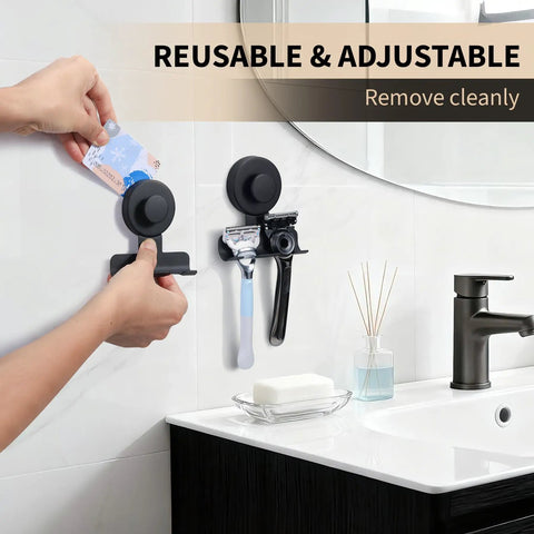 Two Matte Black Shower Razor Holders With Heavy Duty Suction Cups and Razors Mounted on Bathroom Wall Near a Mirror and Sink