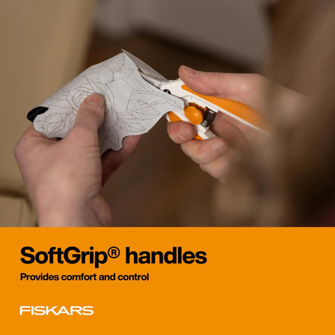 Person using Micro Tip Spring Assisted Scissors for precision fabric cutting with SoftGrip handles for comfort.