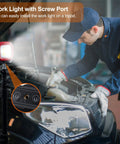 Beast COB LED Work Light With 42 LEDs, 1000 Lumens, on a tripod illuminating a mechanic working on a car engine.