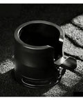 Perfect Your Daily Grind With This Top Shelf Height Adjustable Coffee Tamping Station Built For 58mm Portafilters And Equipped With A Thick Silicone Base, close-up of black tamping station.