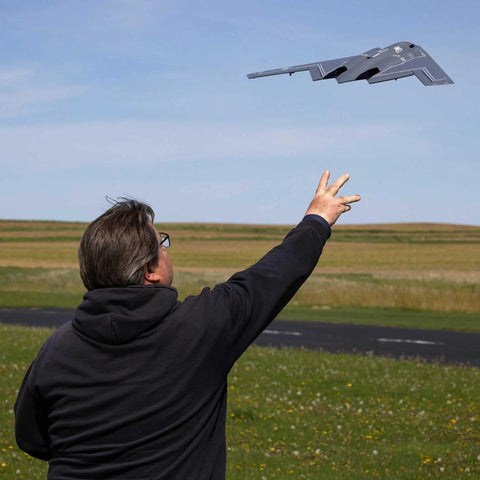 Person launching Spirit Of America Twin 30mm EDF RC Warbird Micro Airplane BNF Basic With SAFE Select outdoors