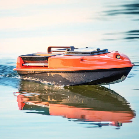 Orange RC boat on water using RC Boat Drive Shaft Kit With 36mm Propeller And Universal Joint, 100mm Shaft, 25mm Sleeve for performance.