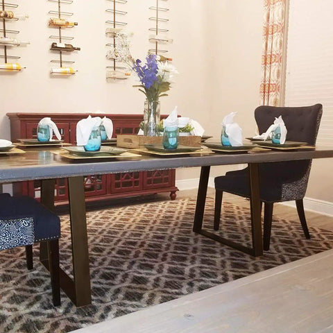 Dining table setup with Beefy 28 Inch Trapezoid Metal Table Legs 2 Pack Solid Steel DIY Furniture Legs, surrounded by chairs.