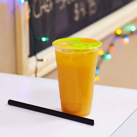 A sealed cup of orange juice using the 95mm PP Sealing Film Roll With Fruit Graphic Design For Sealing Machines, Generic Seal Film.