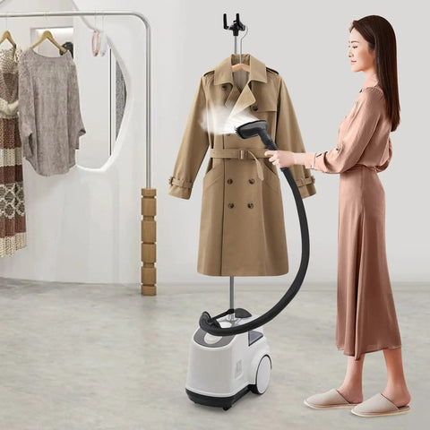 Person using Pro Grade Garment Steamer 110V 1500W with adjustable steam temperature on a beige coat in a modern room.