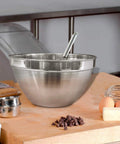 V Shaped 5 Qt Stainless Steel Mixing Bowl With Polished Finish Perfect For Baking Muffins Mixing Sauces And Melting Chocolate On A Double Boiler Durable Go To Kitchen Must Have For Home Cooks And Pros, on a kitchen counter with ingredients