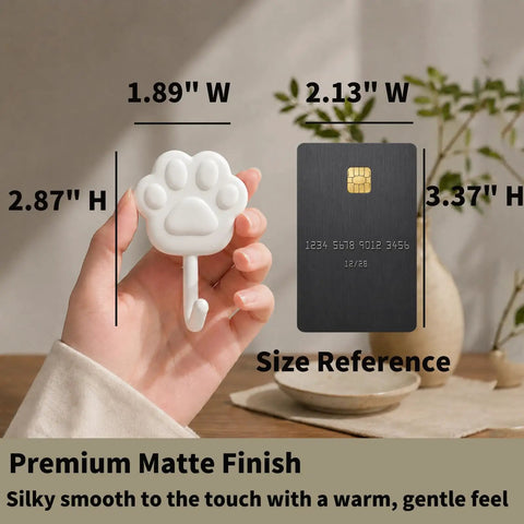 Top Shelf White Self Adhesive Wall Hooks Featuring Chic Paw And Oval Designs for Quick Snap Installation, measuring 1.89" W x 2.87" H.