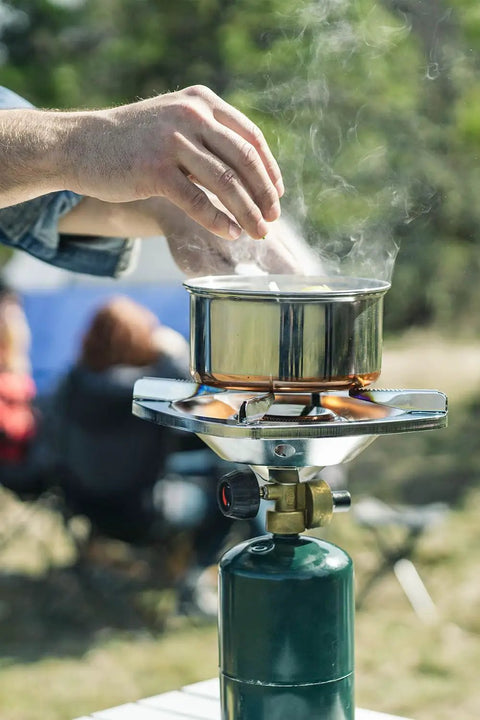 Portable Propane Stove With 10,000 BTU Burner Chrome Anti-Clog Design On Off Regulator Seven Point Five Inch Cooking Grid in use outdoors