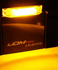Close-up of Smoked Lens Amber LED Grille Lights Kit for 2014-2021 Toyota Tundra in use, showing bright amber light.