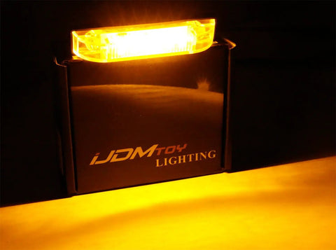 Close-up of Smoked Lens Amber LED Grille Lights Kit for 2014-2021 Toyota Tundra in use, showing bright amber light.