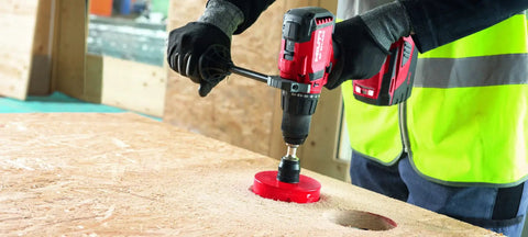 Worker using Cordless Hammer Drill Driver SF 6H A22 Bulk for brick masonry and concrete jobs, drilling into wood surface.