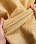 Hands holding yellow 90 Percent Shade Cloth 9x30ft UV Block Outdoor Go To Patio Shade Cover Permeable And Tear Fade Resistant fabric close-up.