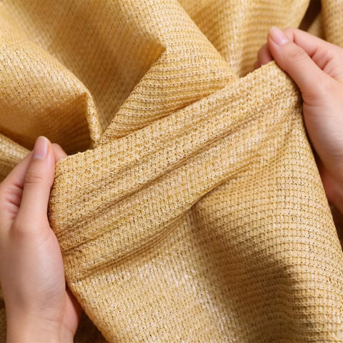 Hands holding yellow 90 Percent Shade Cloth 9x30ft UV Block Outdoor Go To Patio Shade Cover Permeable And Tear Fade Resistant fabric close-up.
