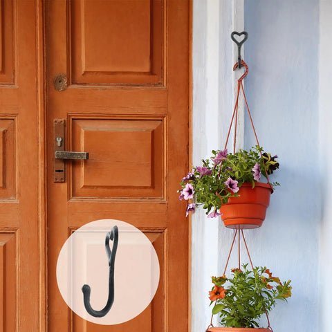 Dope Black Cast Iron Heart Shaped Wall Hooks For Home Decor Vibes And Closet Organization Heavy Duty Decorative Craft Hanging Hardware Reliable Set Of Two Pieces, holding a flower pot.