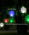 Inflatable Solar Floating Pool Lights Glow Globes 14 Inch Waterproof IP68 LED Lit Color Changing Night Lights hung in a garden at night
