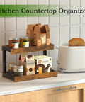 Two Tier Countertop Spice Rack Organizer In Rustic Brown Wood Finish with jars and boxes on kitchen counter next to toaster.