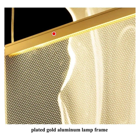 Close-up of the plated gold aluminum lamp frame from the Sleek Modern Acrylic Led Chandelier Drops Fresh Warm Glow For Living And Dining Rooms With Hand Polished Metal Accents Delivering A Killer Minimalist Indoor Pendant Vibe For Home Decor.