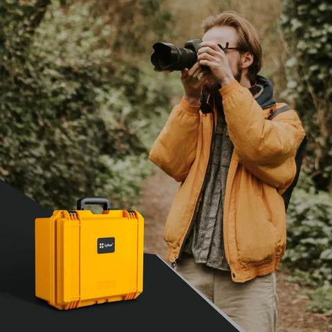 Yellow Waterproof PVC1 Hard Camera Case With Padded Dividers For Cameras Lenses And Dual Drones next to photographer outdoors