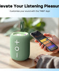 Green StormBox Mini Plus Portable Bluetooth Speaker With 360 Surround Sound, 12W Output, IPX7 Waterproof next to a smartphone.