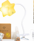 LED Clip On Star Light With Warm Dimmable Glow on gooseneck with remote control and flexible clip mount, shown in nursery setting