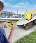 Child playing with SpongeBob Boatmobile RC Kart Racer 2.4GHz, Full Function Remote Control Vehicle With Grippy Tires For Maximum Traction