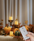 Remote Control Flameless Votive Candles 12 Pack Flickering Battery Operated LED Tealight Candles For Cozy Wedding And Christmas Decor Amber Yellow Batteries Included shown with remote in autumn decor.
