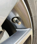Close-up of silver wheel tire valve with heavy duty brass tire valve cap with O-ring seal, TPMS safe, dust and leak proof