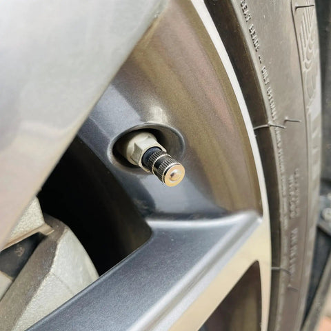 Close-up of wheel with Heavy Duty Brass Tire Valve Caps 25 Pack With O Ring Seal Dust Proof And Leak Proof Air Protection Chrome Silver Round Caps Easy Install For All Valve Stems TPMS Safe Lightweight installed