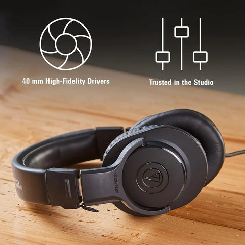 M20x Professional Studio Headphones For Mixing And Monitoring, Lightweight Circumaural Over Ear Design rests on wood surface