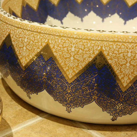 Close-up of Knockout Round Ceramic Vessel Sink With A Dope Sprayed Enamel Finish featuring intricate blue and gold design.