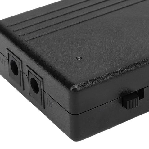 Solid 7800mAh UPS Power Supply For Router And Modem Backups Delivers Steady 24 Watts, black protective casing with input and output ports.