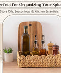 Wicker basket with bottles and spices on a countertop, decorative plant and cutting board in background.