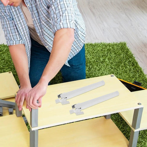 Person assembling desk with Four Pack Portable White Plastic Table Legs With Easy Install Adjustable Height Replacement Legs