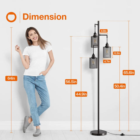Woman standing beside LED Industrial Floor Lamp With Three Cage Heads And Edison Bulbs, showcasing dimensions in room setting.
