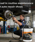 Mechanic using Heavy Duty Pneumatic Grease Pump For Industrial Lubrication with bucket-type gun and 19.6 ft hose in workshop