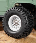 1.0 Inch Maverix MT Tires 57x22mm for 1/18 and 1/24 RC Crawlers mounted on off-road vehicle in rocky terrain
