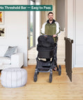 Man with stroller passing through Auto Close Baby and Dog Gate for Stairs and Hallways 2 In 1 Swing Doorway and Hallway Pet Gate Black