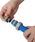Hand connecting metal fitting to Boss Grade Blue Air Compressor Piping Tube 3/4 Inch X 200 Feet for leaks-free setup.