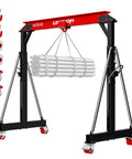 Heavy Duty 3 Ton Gantry Crane 6600 Lbs Heavy Liftin Power With Manual Trolley Hook And Shackles Portable Workshop Hoist holding pipes.