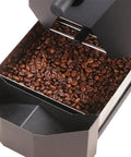 Kick Start Your Morning Vibe With This Electric Home Coffee Roaster featuring roasted coffee beans inside a compact roasting chamber.