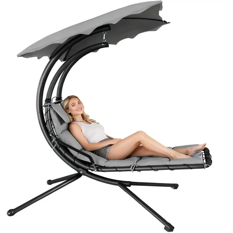 Woman lounging on Chaise Lounger Swing Chair With Umbrella Canopy For Outdoor Patio And Indoor Use Hanging Lounge With Stand