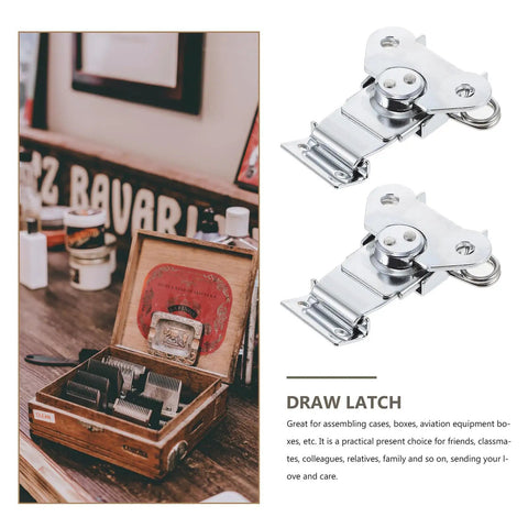 Spring Loaded Stainless Steel Butterfly Latches For Wooden Boxes Decorative Draw Latches With Silver Finish Heavy Duty Quick Release Clasps For Office And Shop Use Three Piece Set beside a wooden box on a table.