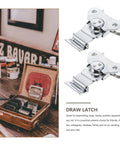 Spring Loaded Butterfly Latches Three Piece Set Stainless Steel Heavy Duty Built To Last Decorative Latches next to wooden box