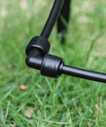 Close-up of One Quarter Inch Drip Irrigation Elbow Coupling Connector Quick Connect Garden Hose Elbow Connector on grass