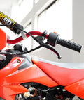 Left Seven Eighths Inch Clutch And Brake Lever Perch For KX Dirt Bikes KX60-125 mounted on red dirt bike handlebar
