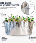 Armored XL Insulated Beverage Tub for Parties, Double Wall Stainless Steel Ice Bucket filled with beer bottles, 6.25 gallon capacity