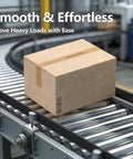 Cardboard box on conveyor system with stainless steel rollers, showcasing heavy-duty transport capability in an industrial setting.