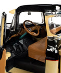 Interior view of 1957 Chevy 3100 Stepside Diecast Pickup 1 18 Scale Black And Tan Model With Opening Doors, showing realistic details.